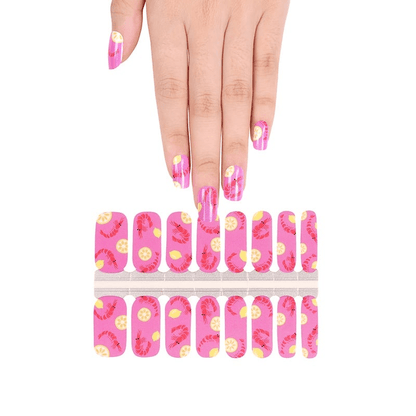 Hand above pink prawn nail wrap sheet showing at-home manicure application