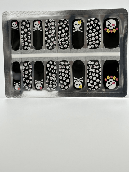 Gothic skull pattern nail wraps sheet showing black base with white skulls and crossbones design