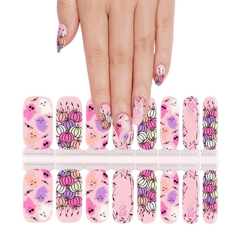 Halloween nail art wraps with kawaii characters displayed with hand model