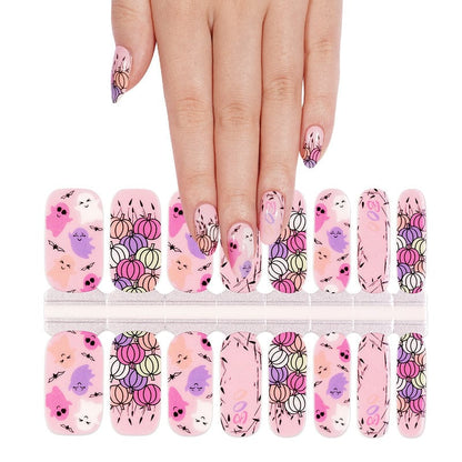 Halloween nail art wraps with kawaii characters displayed with hand model