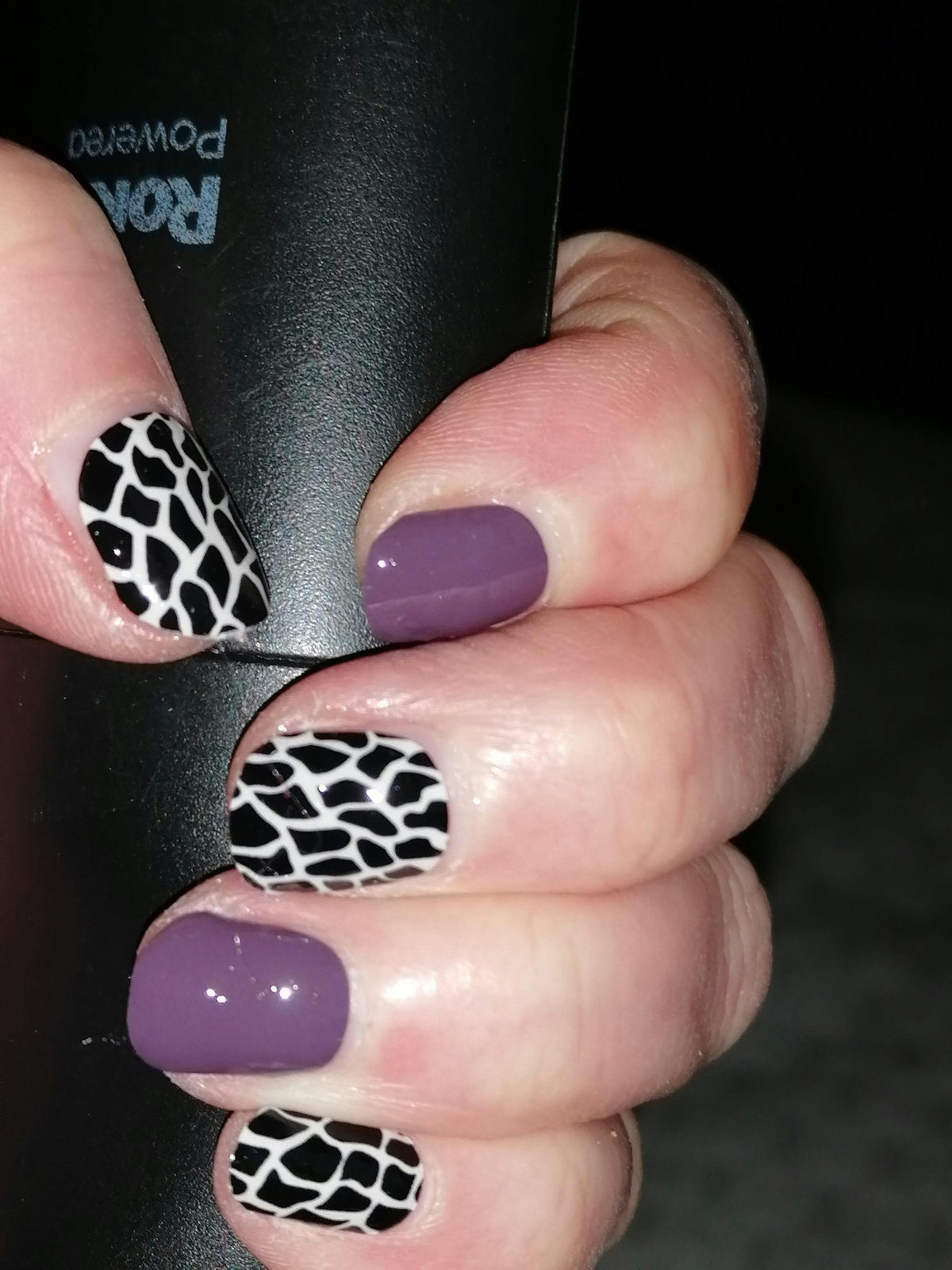 Glossy mauve nail wraps alternating with black and white python print pattern