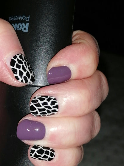 Glossy mauve nail wraps alternating with black and white python print pattern