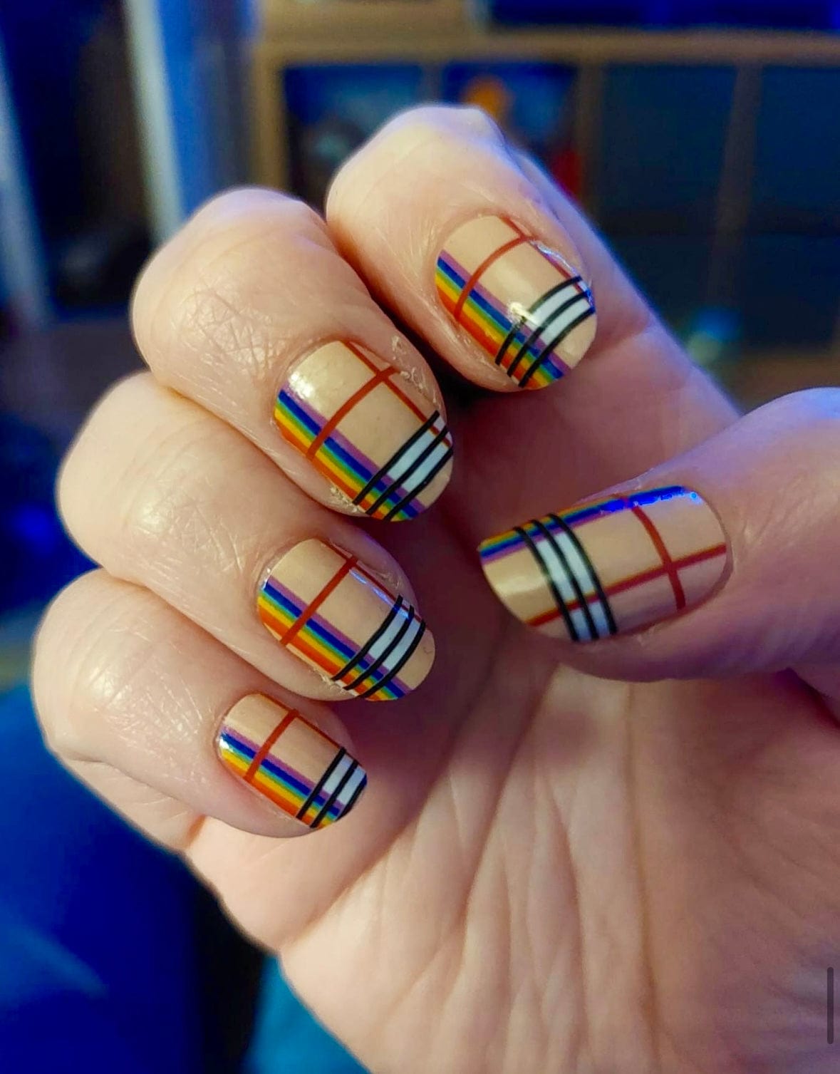 Nude nail wraps with glossy rainbow-striped plaid pattern in a classic tartan design