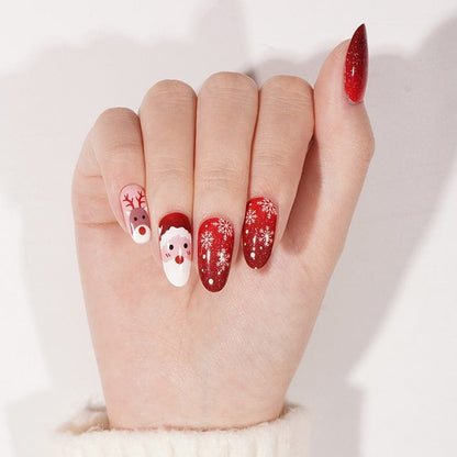 Hand wearing festive Christmas nail wraps featuring Santa Rudolf reindeer and red glitter