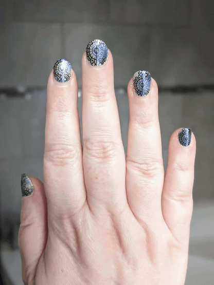 Rainbow holographic nail wraps with decorative lace pattern on fingertips manicure