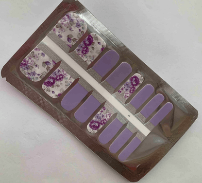 Purple lavender pedicure nail wraps with vintage rose floral patterns in packaging
