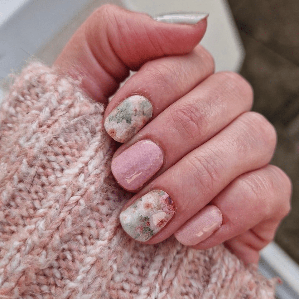 Pink and floral watercolour nail wraps on hand showing romantic rose garden design