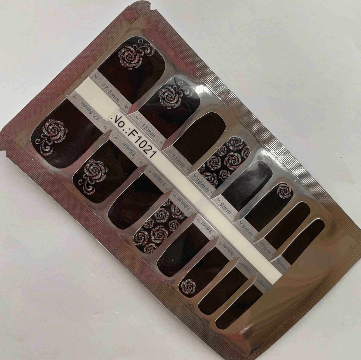 Rose noir pedicure nail wraps packaging showing black background with white floral patterns