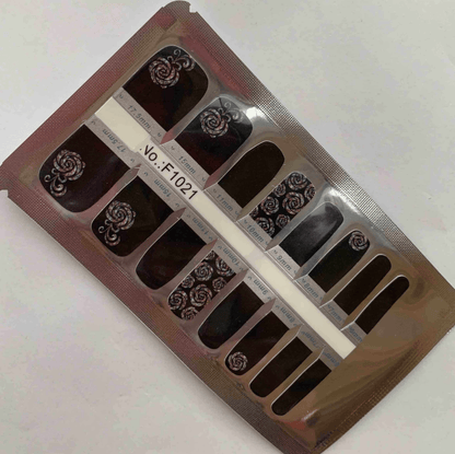 Rose noir pedicure nail wraps packaging showing black background with white floral patterns