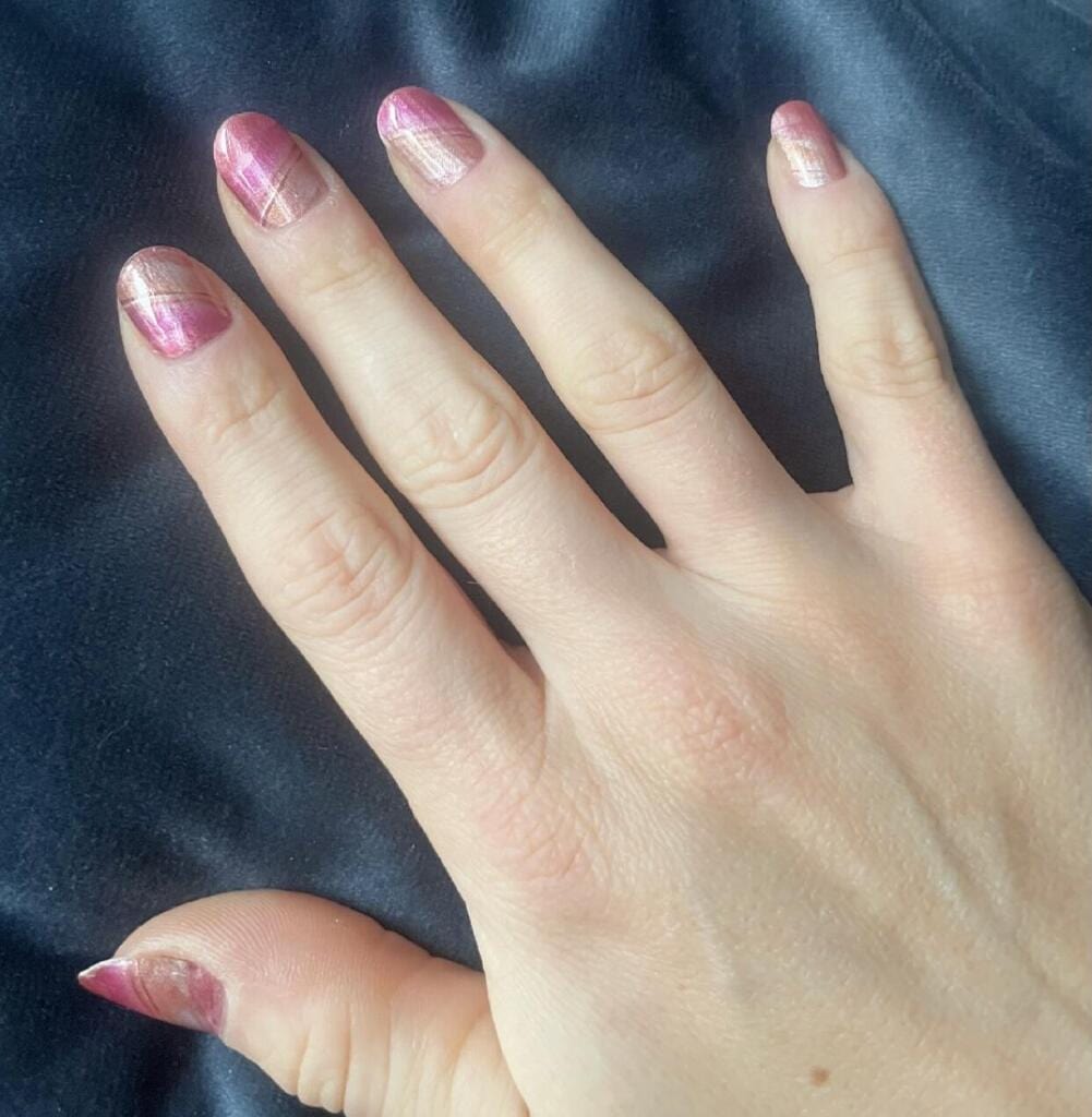 Rose marble nail art wraps on hand showing pink gradient stone pattern manicure