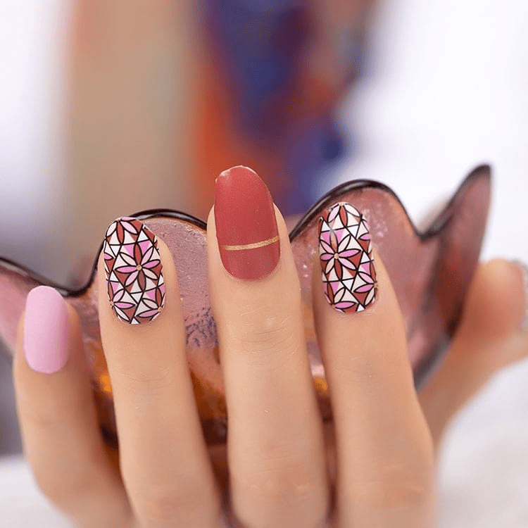 Holy Classics nail wraps: pink, rust and white stained-glass floral pattern with solid rust accent nail