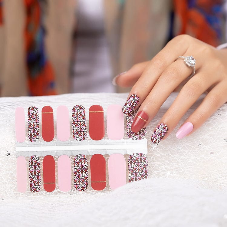Non-UV nail wraps sheet showing red and pink shades with intricate floral geometric designs