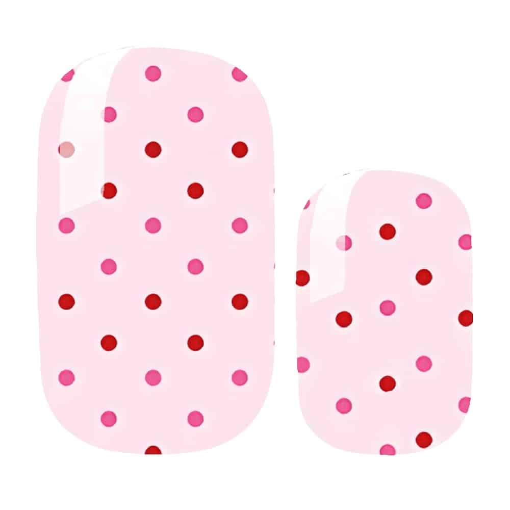 Pink polka dot nail wraps with red and pink spots on pale background