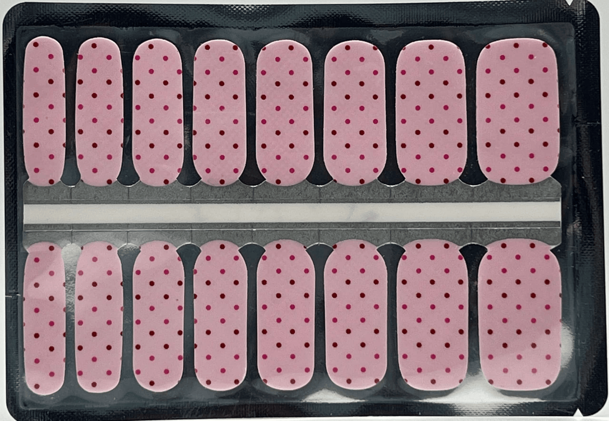 Pink polka dot nail wraps with burgundy spots in classic manicure strip format