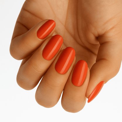 Glossy burnt-orange nail wraps in a solid rust shade on almond-shaped nails