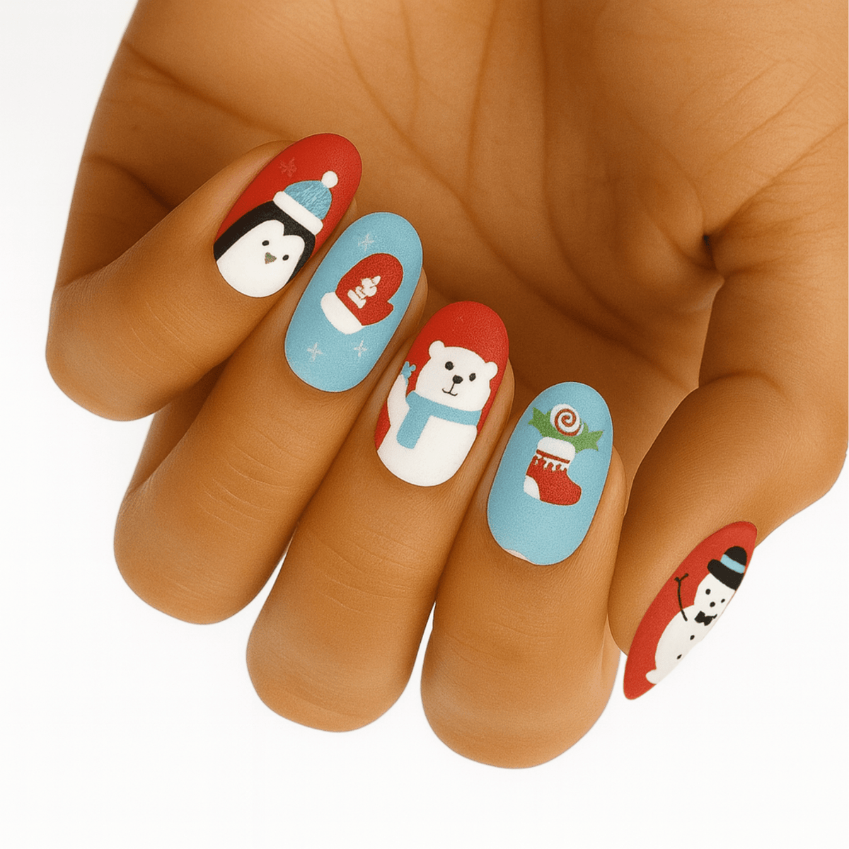 Christmas nail wraps on hand featuring cute Santa, snowman and festive characters in red and blue
