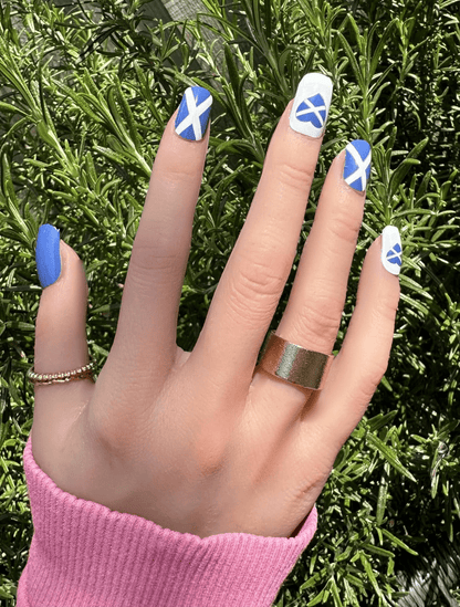 Scottish saltire flag nail wraps blue white patriotic design on hand with gold ring