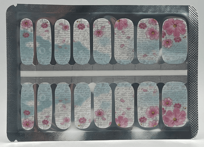 Pink floral script nail wraps with blue accents and vintage text pattern on clear backing