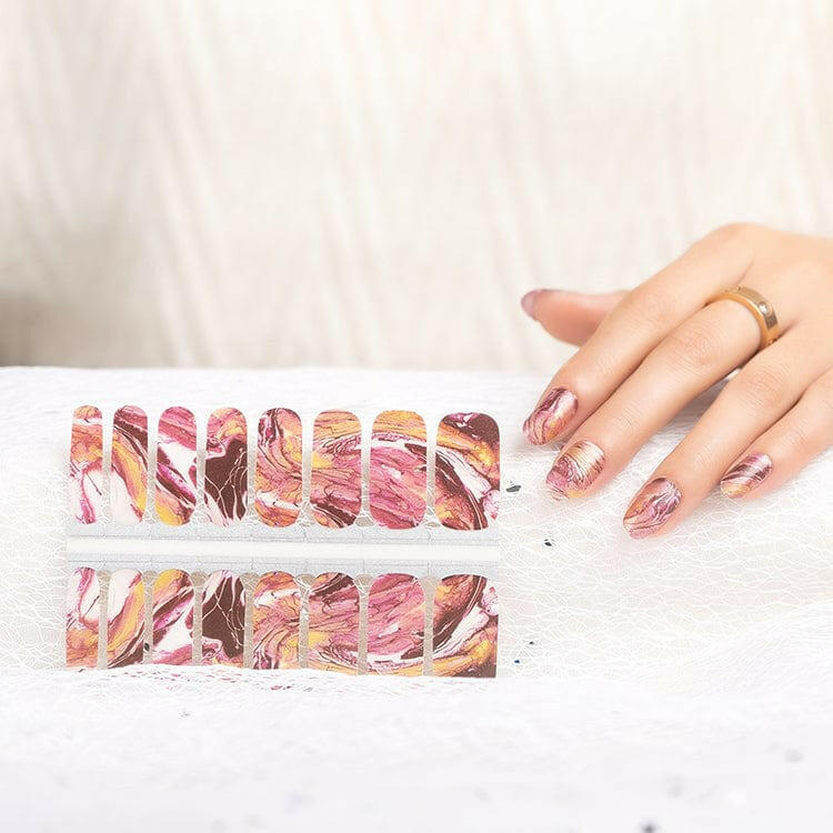 Nail wraps in marbled pink, burgundy and gold sedimentary rock pattern, glossy finish