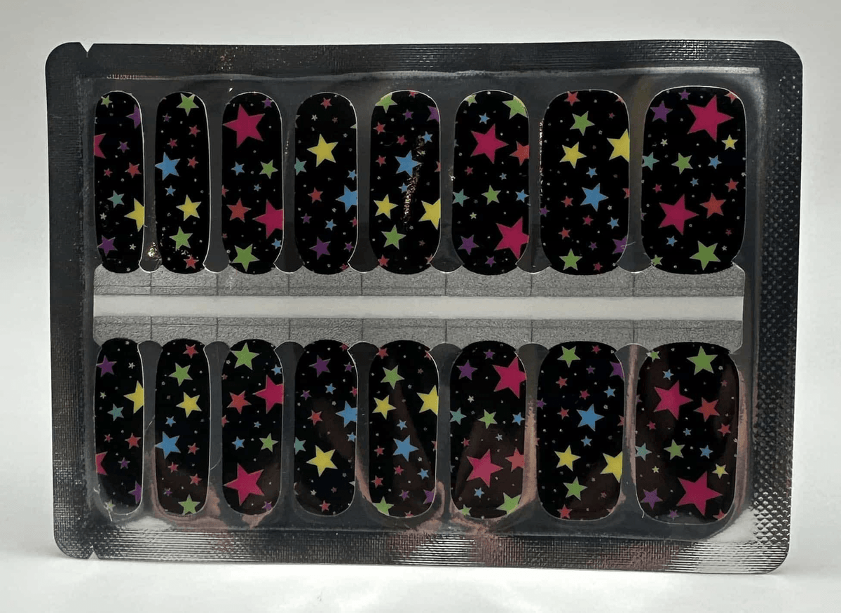 Black nail wraps with multicoloured star pattern in rainbow colours for at-home manicure