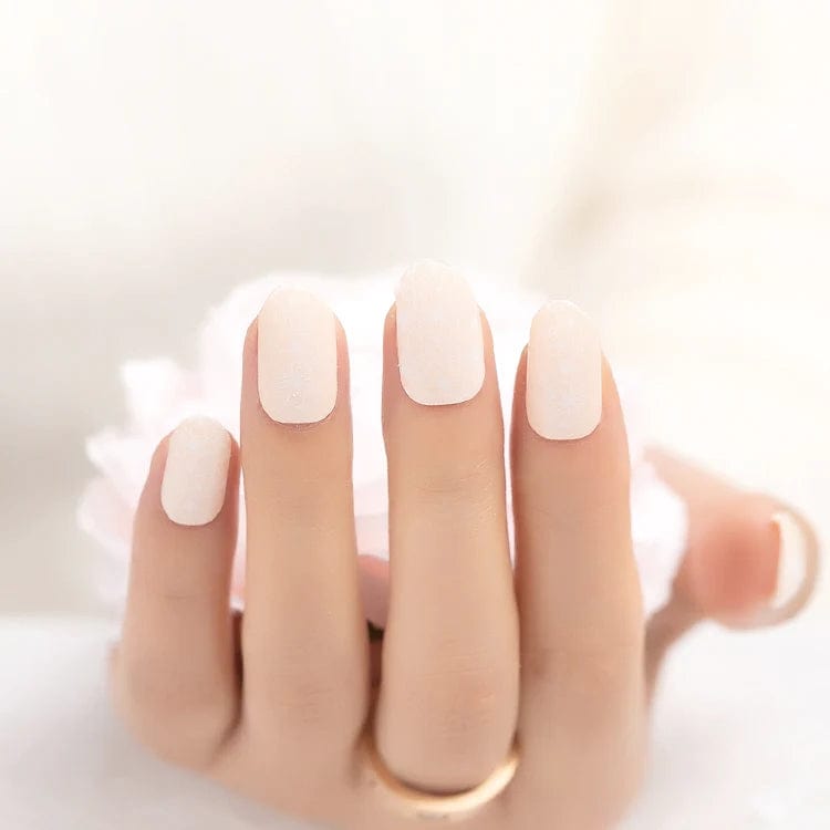 Elegant nude pink nail wraps with delicate lace pattern on hand manicure