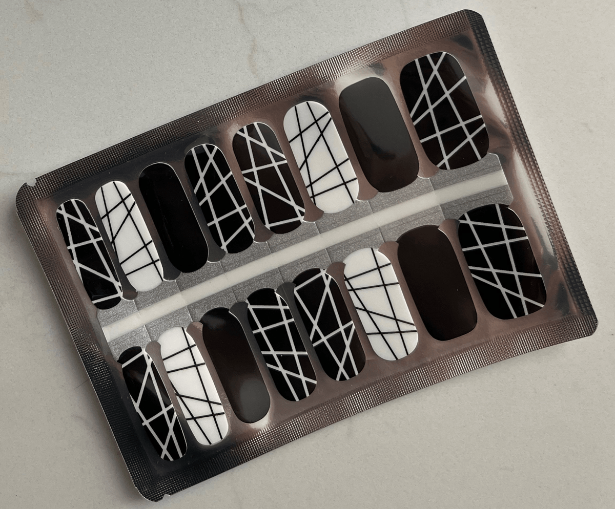 Black and white geometric crosshatch pattern nail wraps in packaging sheet