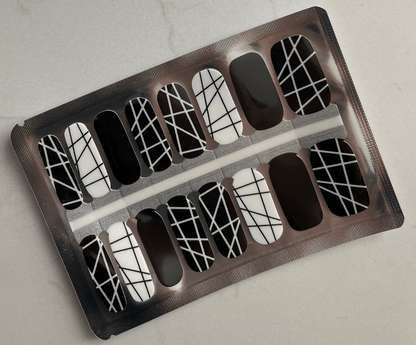 Black and white geometric crosshatch pattern nail wraps in packaging sheet