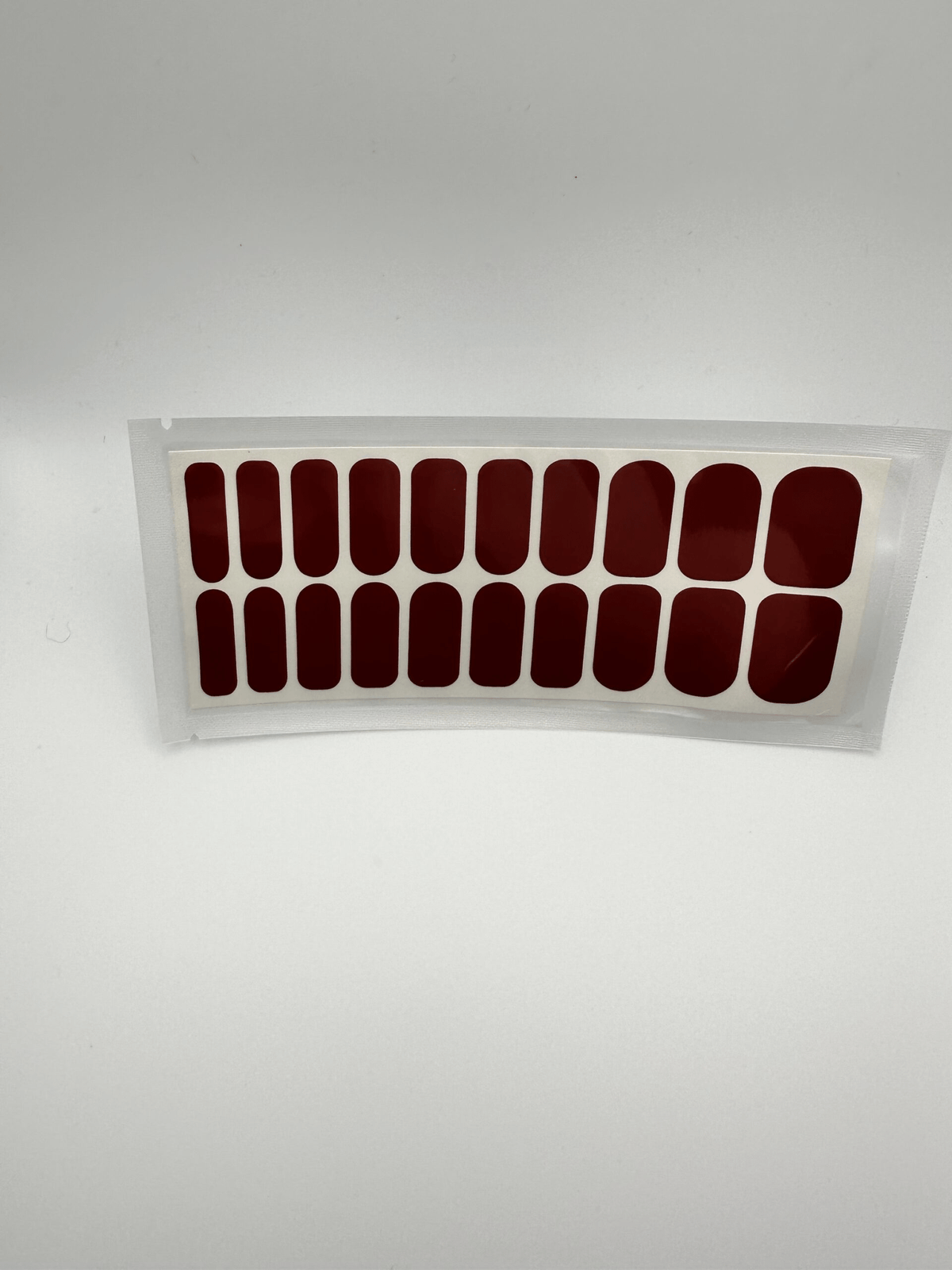Wide fit burgundy nail wraps set showing 20 piece glossy red manicure wraps