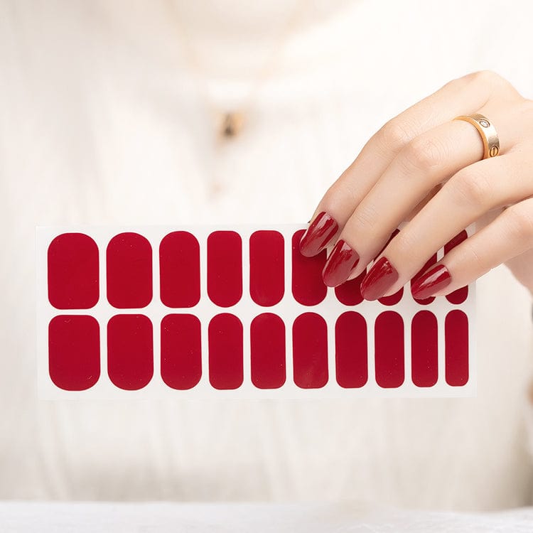 Deep red nail wrap sheet showing 20 burgundy glossy nail wraps for at-home manicure
