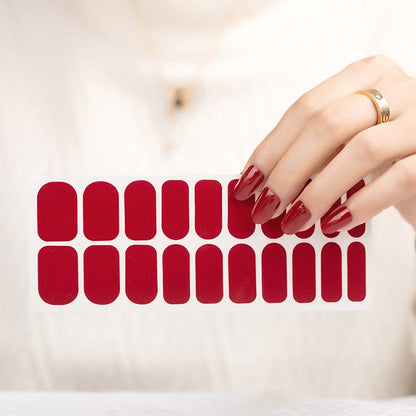 Deep red nail wrap sheet showing 20 burgundy glossy nail wraps for at-home manicure