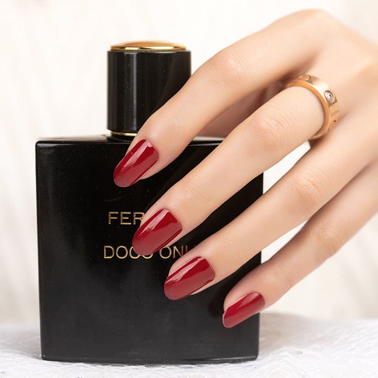 Deep wine red nail wraps with glossy finish on almond-shaped nails, wide fit