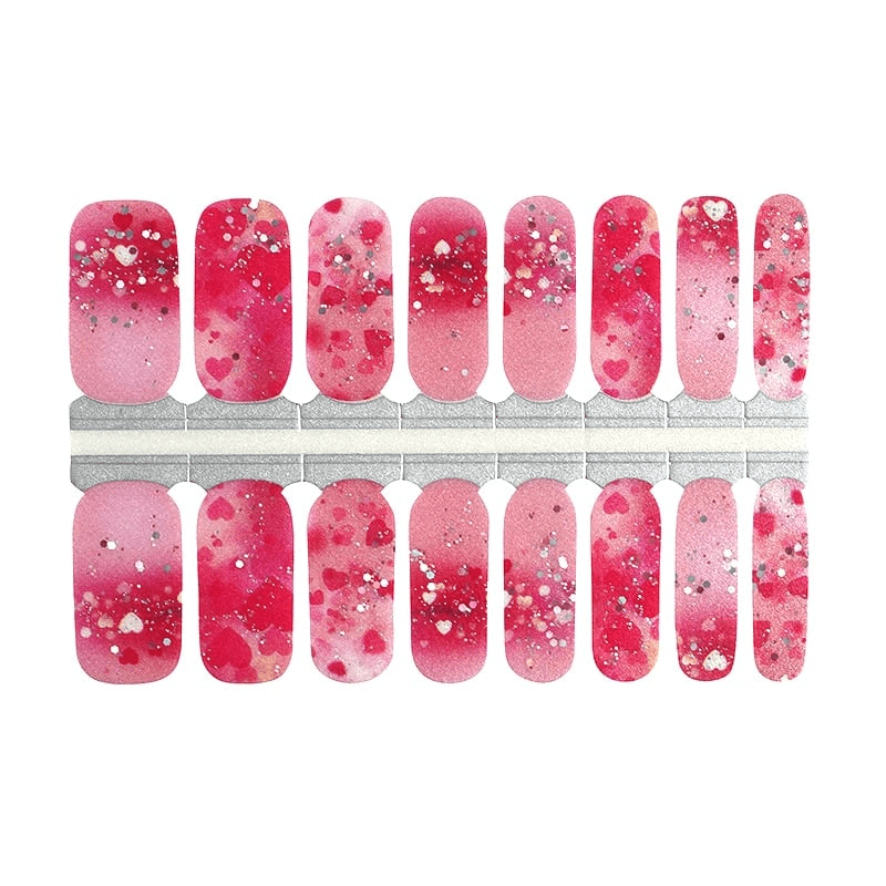 Pink ombré nail wraps with heart print, silver glitter flecks and splatter detail