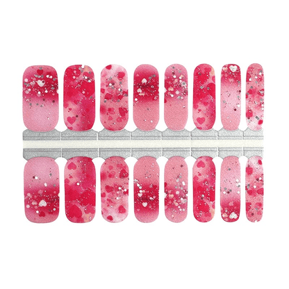 Pink ombré nail wraps with heart print, silver glitter flecks and splatter detail