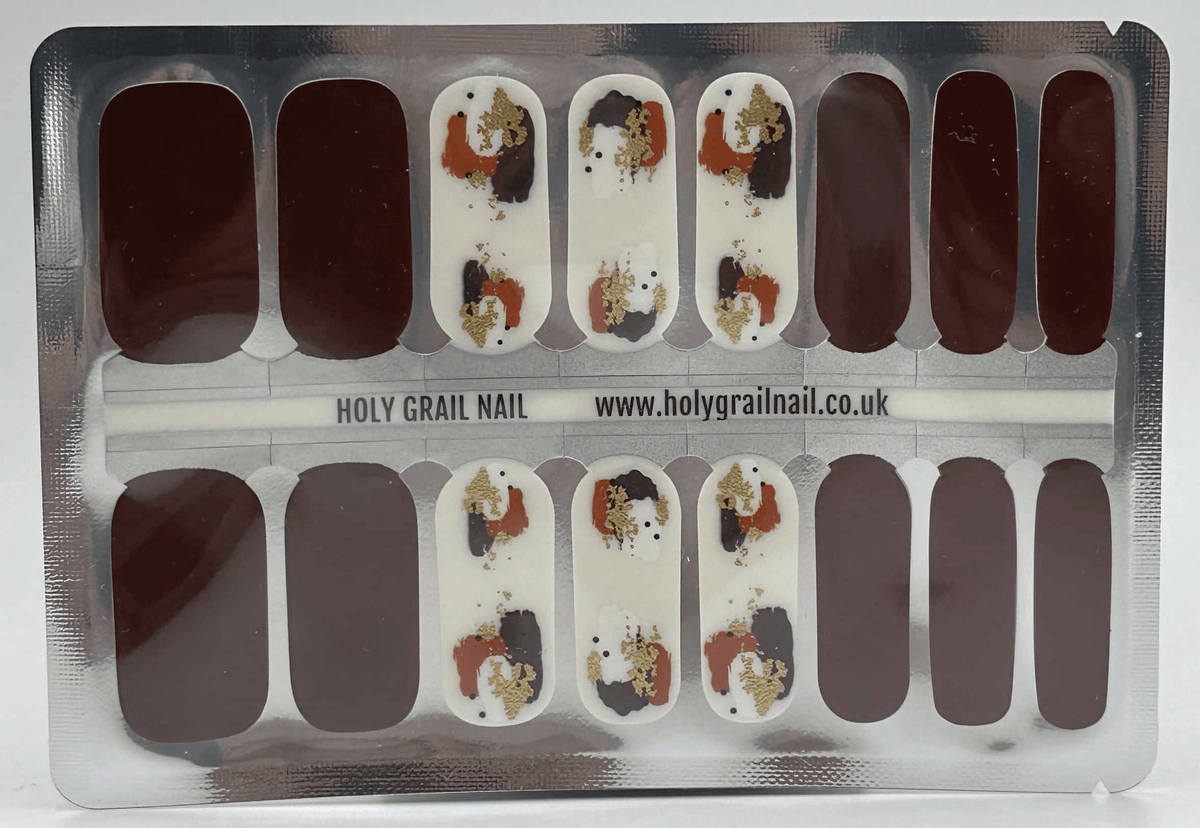 Sheet of burgundy and gold abstract paint splash non-UV nail wraps ready for application