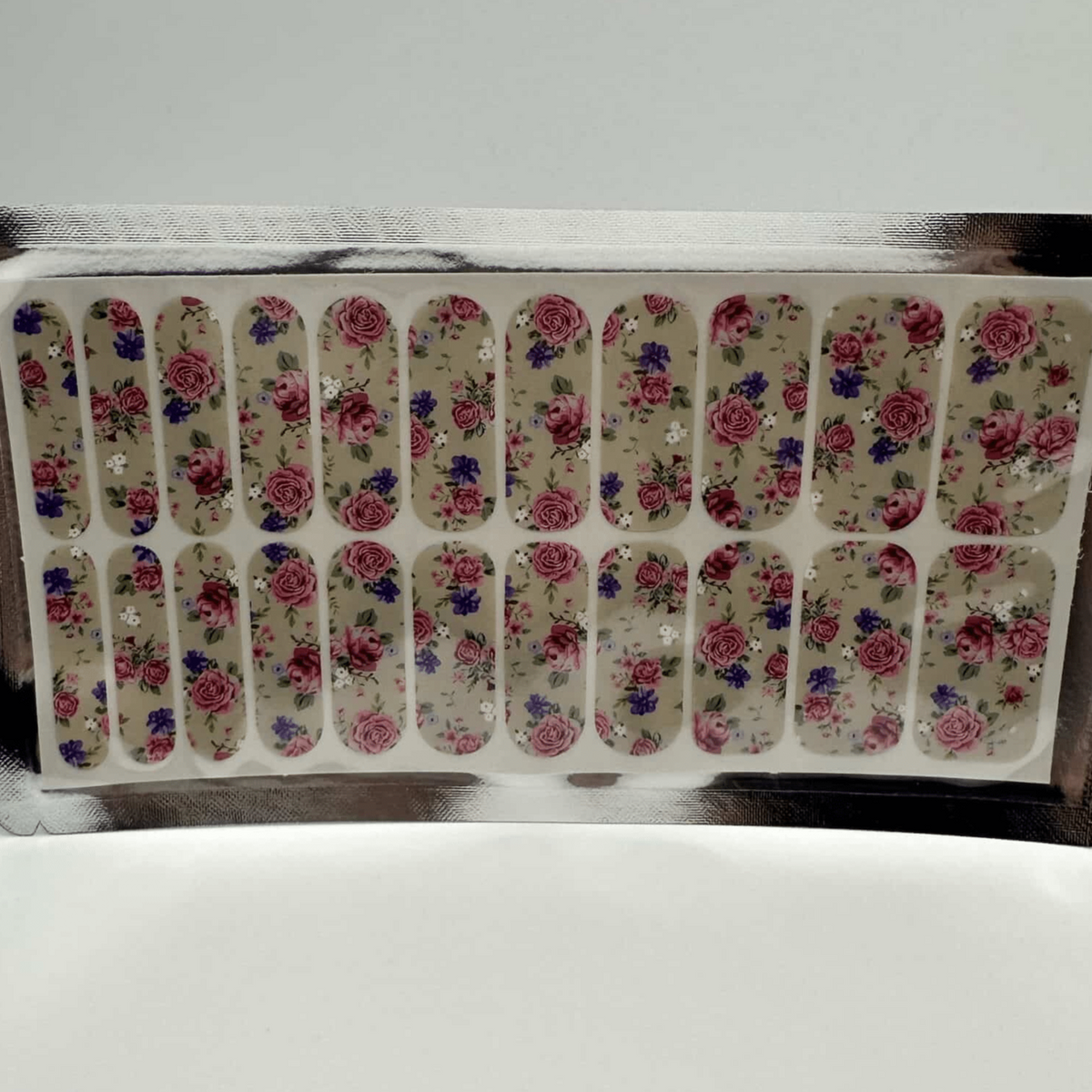 Complete sheet of floral nail wraps featuring pink roses and green leaves