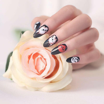 Gothic skull nail wraps on hand with pink rose showing spooky Halloween nail art