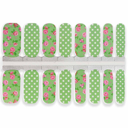 Green nail wraps with pink roses and white polka dots for at-home manicure
