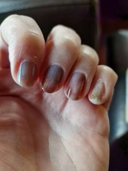 Grey sheer nail wraps on hand displaying subtle marble manicure for everyday wear