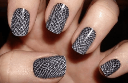 Grey snakeskin nail wraps on hand showing textured animal print manicure