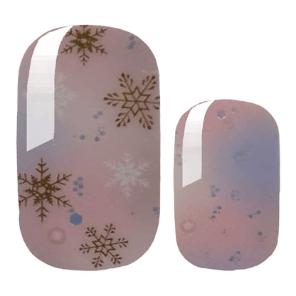 Pink gradient nail wraps with gold snowflake pattern for winter manicure design