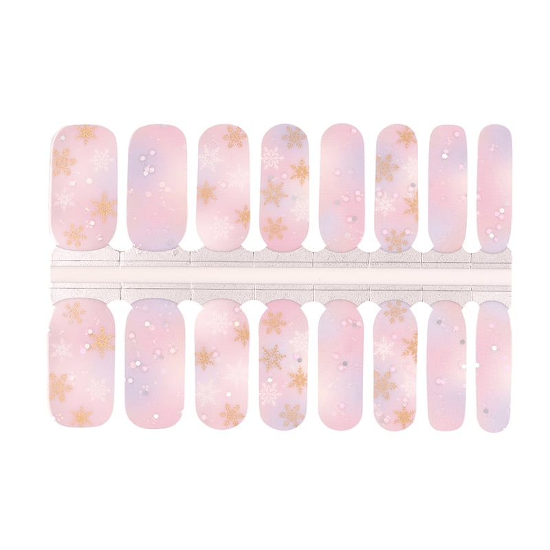 Pink and lilac ombré nail wraps with gold and white snowflakes, glitter accents