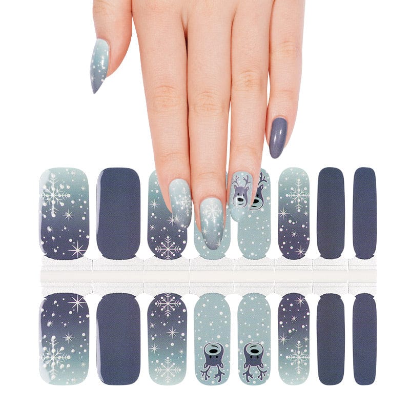 Christmas nail wraps sheet showing blue and grey designs with snowflakes and reindeer patterns