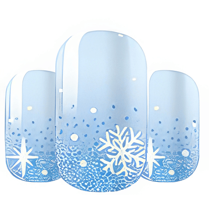 Wide fit nail wraps featuring blue gradient background with white snowflake patterns and glitter accents