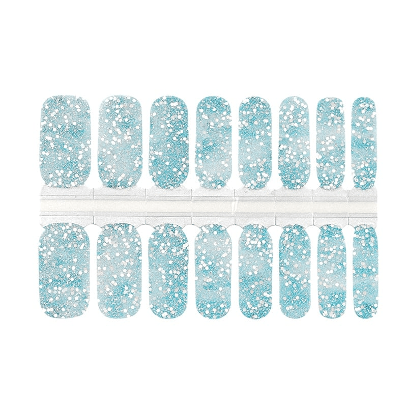 Blue glitter nail wrap sheet with sparkly winter pattern for at-home manicure