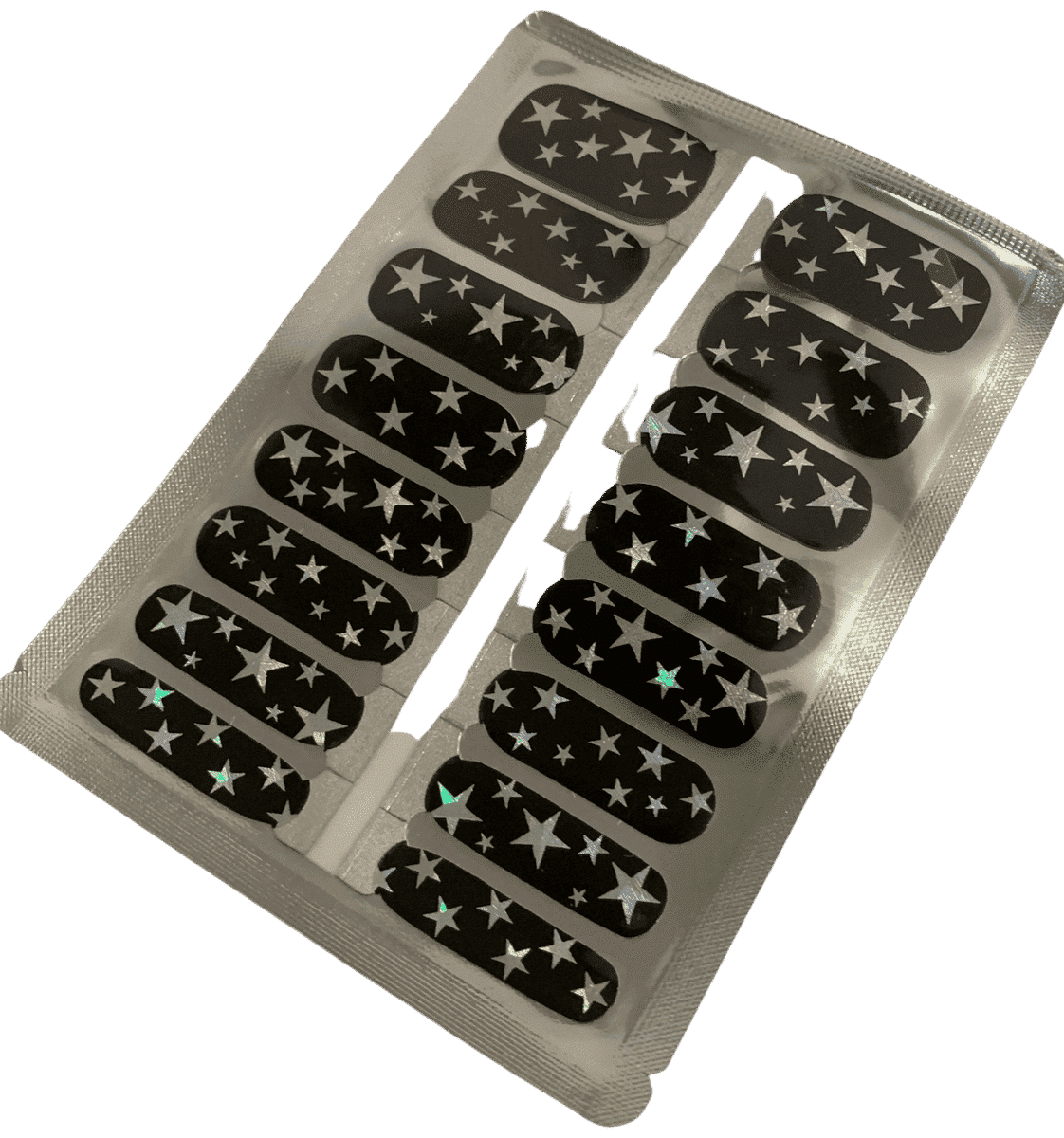 Sheet of black nail wraps with silver star pattern showing adhesive backing strips