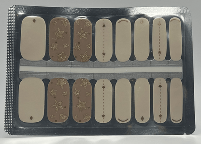 Nail wrap sheet featuring white and champagne designs with gold glitter star patterns