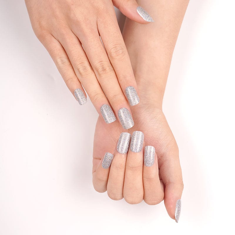 Silver glitter nail wraps with a sparkling metallic finish on squoval nails