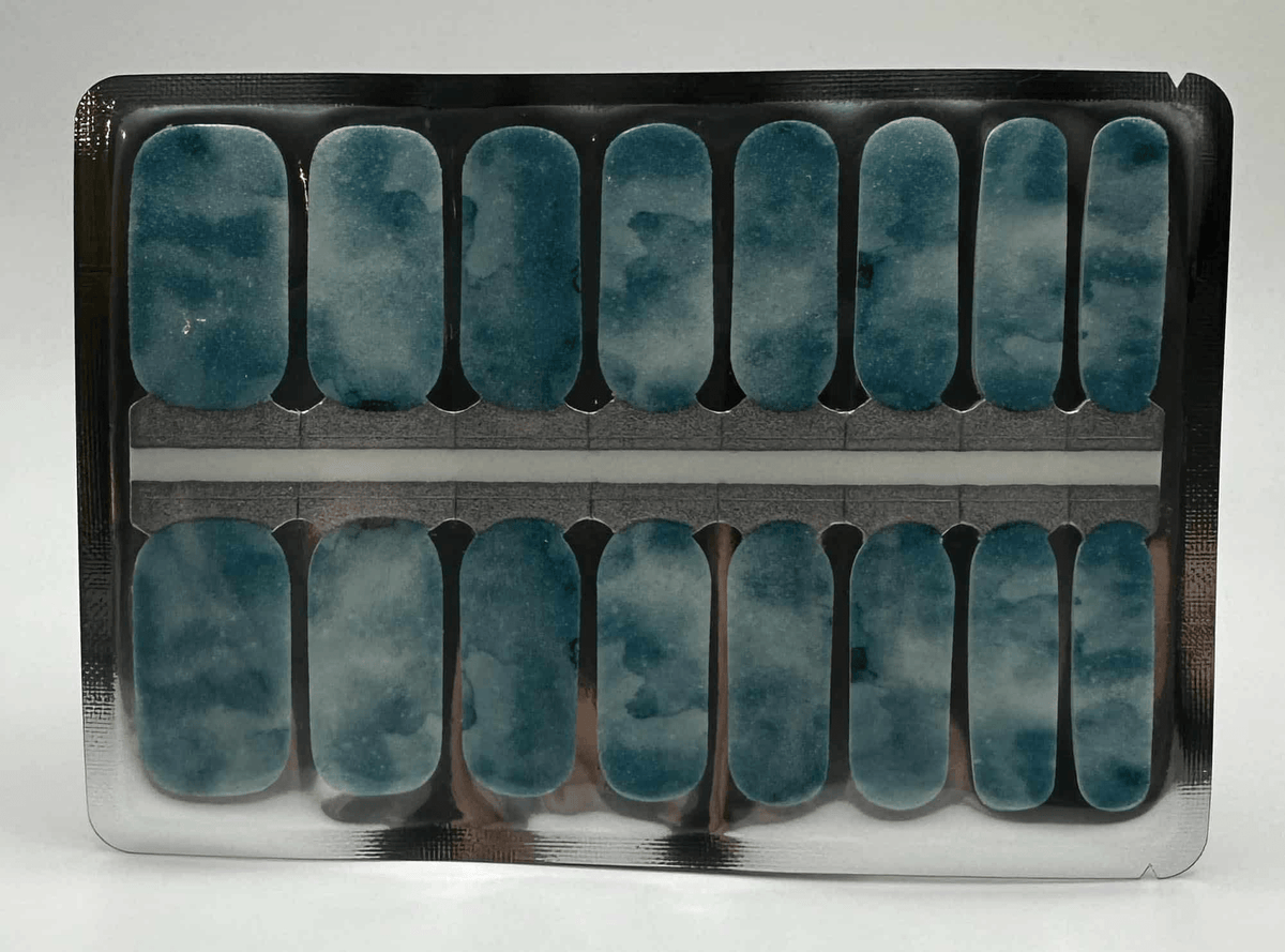 Blue green marble stone nail wraps in packaging tray showing nail art design