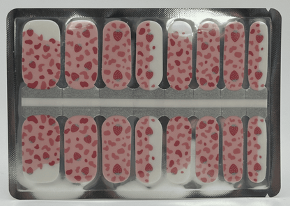 Pink leopard print nail wraps with red strawberries on a cream base