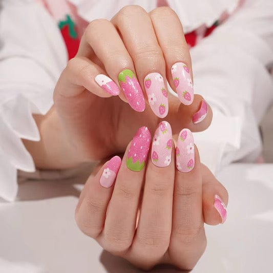 Both hands displaying pink strawberry non-UV nail wraps with polka dot patterns